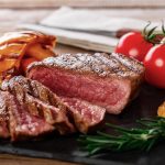grilled-beef-steak-with-vegetables-on-a-wooden-surface